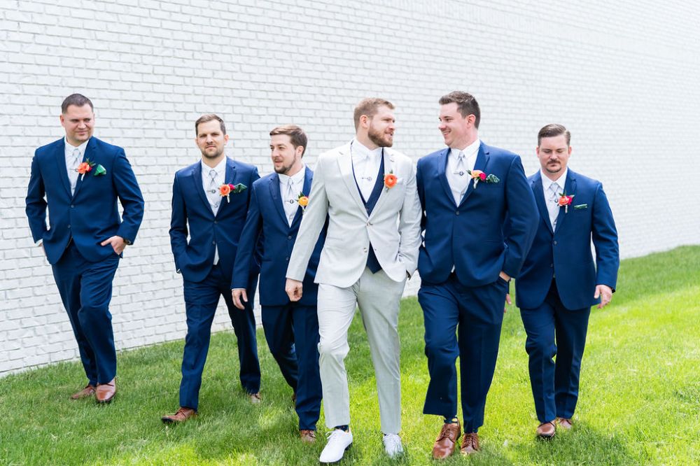 A groom and his wedding party posing for wedding day photos at BASH