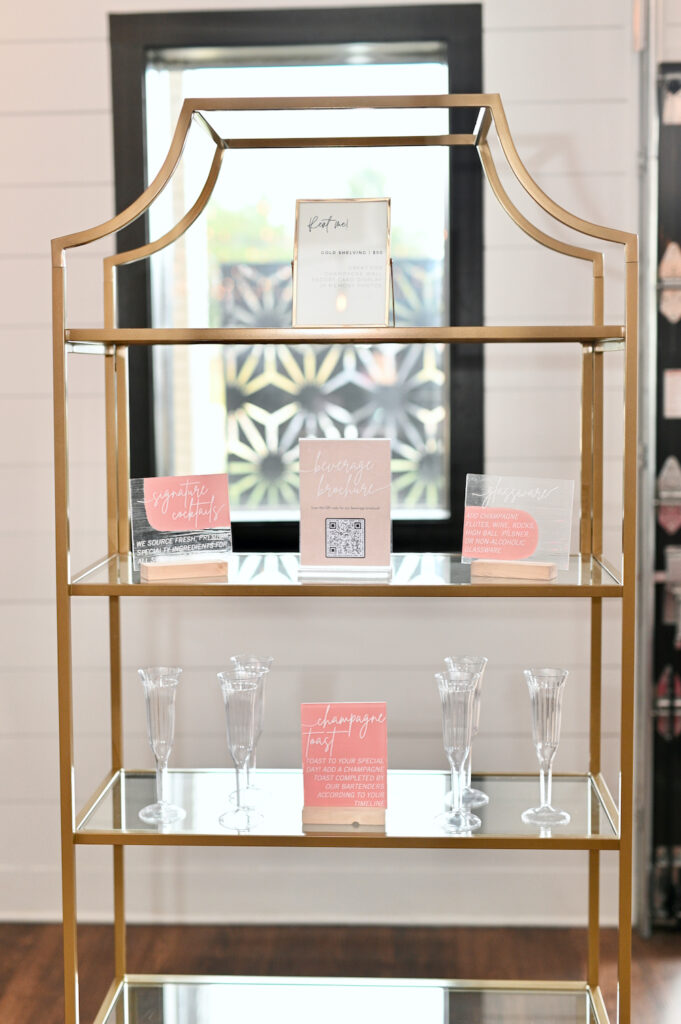 A gold tiered shelf set up with champagne at an event at BASH