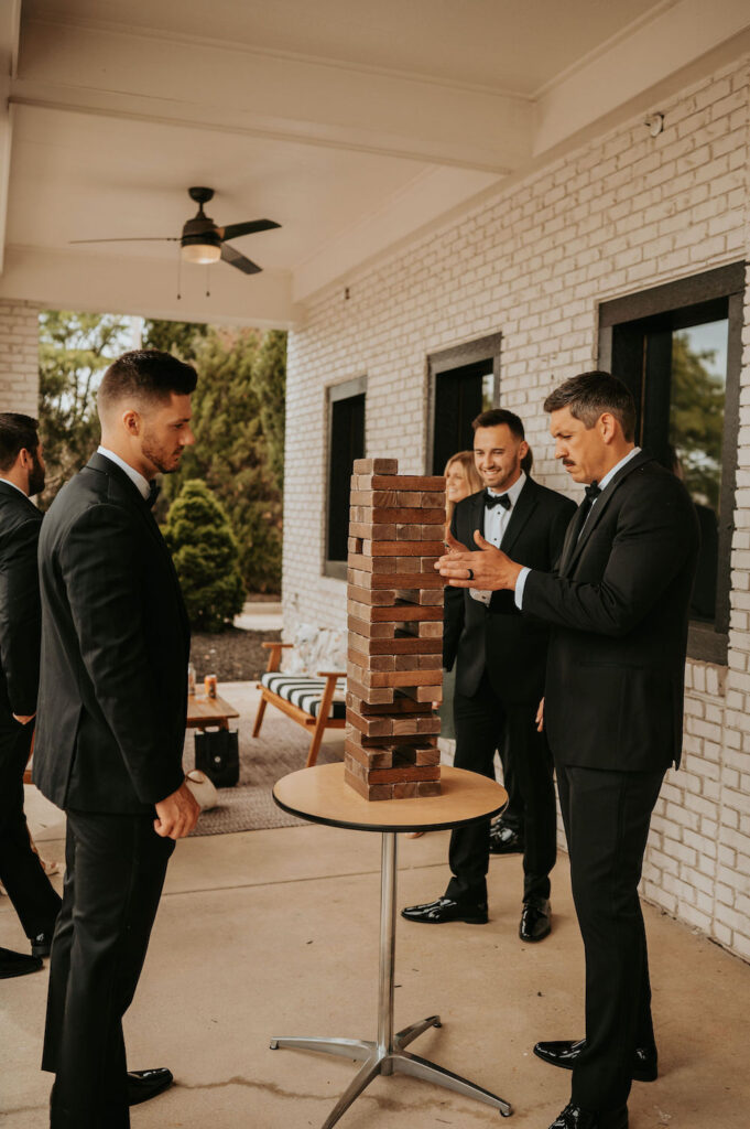 A groom and groomsmen playing jenga at BASH in Carmel, IN