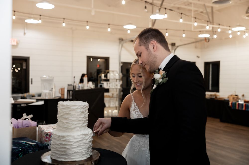 Bride and groom cutting their wedding cake