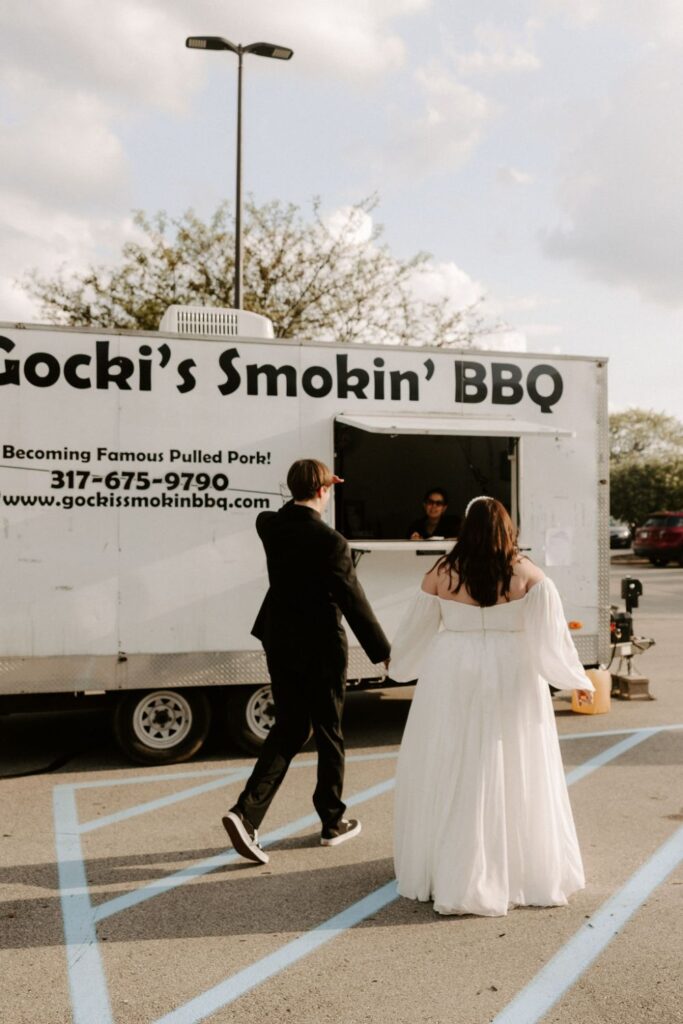 Bride and groom walking out to a food truck at BASH