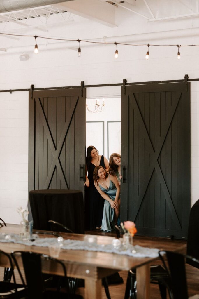 Bridesmaids peeking at First look with bride and groom