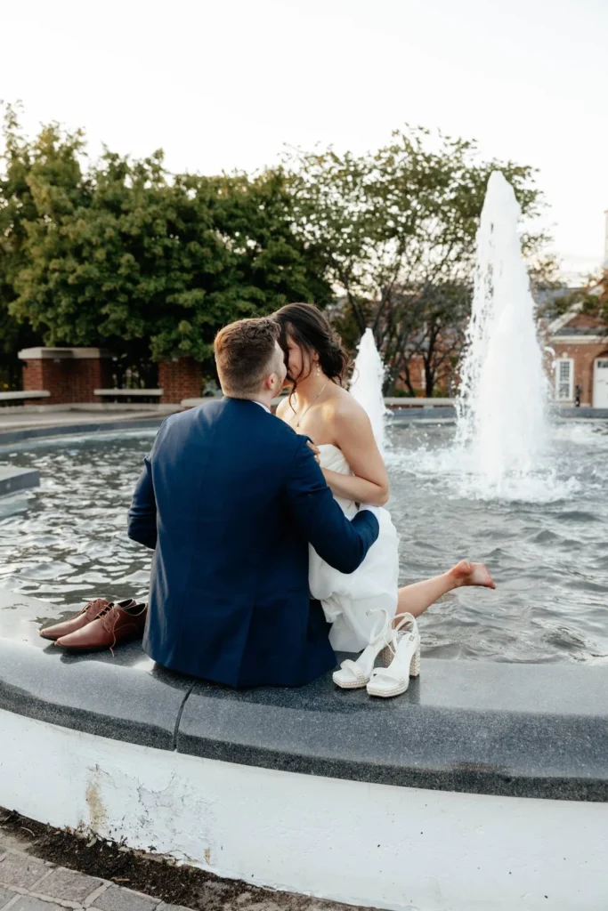 Bride and groom in a fountain in Carmel, IN