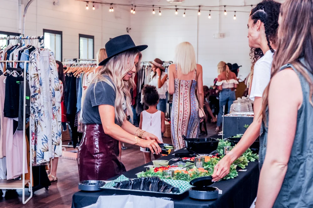 Woman choosing food from a food station at an event.