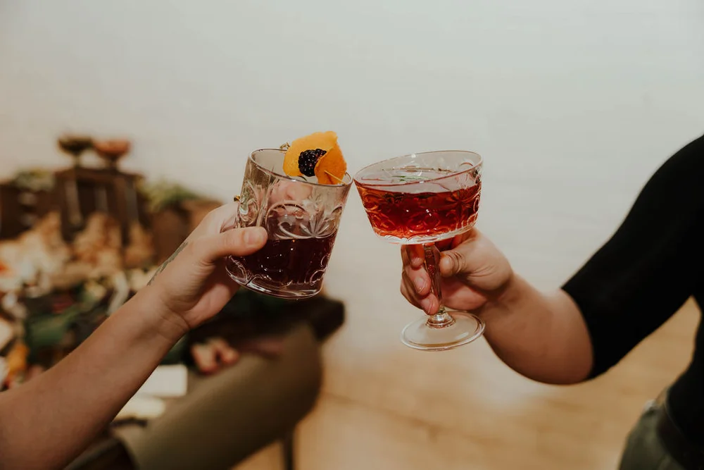 Guests cheers-ing with holiday cocktails at a Carmel corporate holiday party