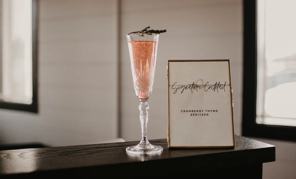 Festive cranberry thyme spritzer in a champagne flute for a Carmel corporate holiday party
