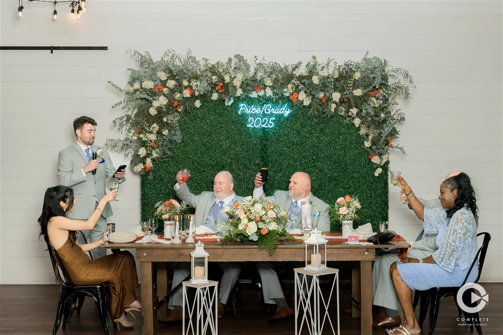 Grooms and guests raising a toast during wedding speeches at BASH Carmel