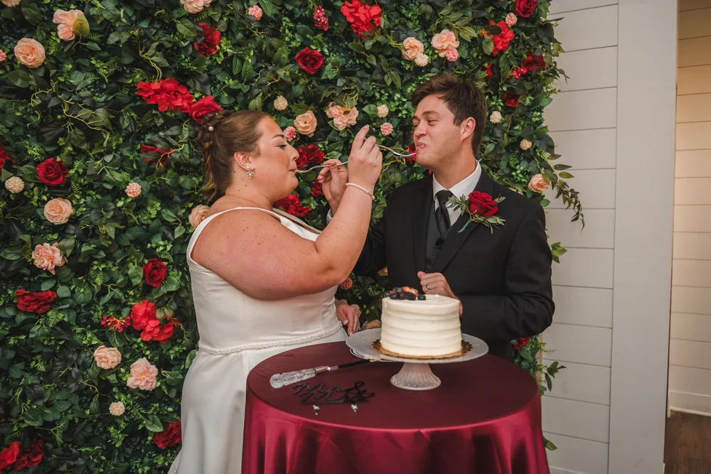 Couple sharing the first bite of their wedding cake at BASH in Carmel, IN