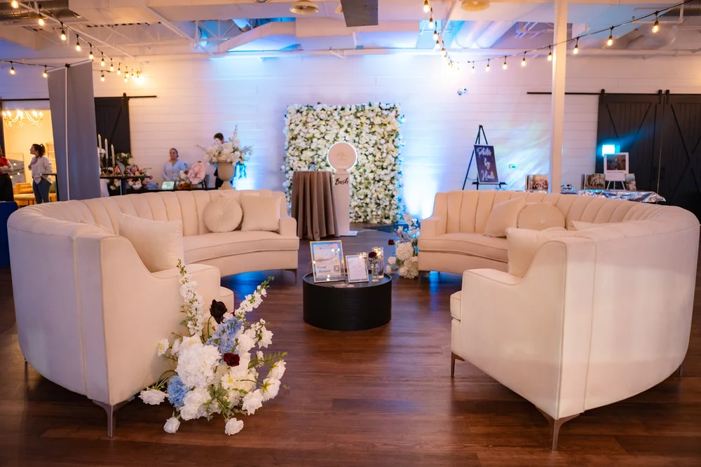 Circular lounge seating area and photo booth at BASH wedding open house in Carmel Indiana